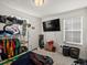 Bedroom with a window, clothing rack, and TV for convenience and relaxation at 21901 E 42Nd Place, Aurora, CO 80019