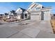 Charming two-story home boasts a stone facade and a spacious three-car garage at 21901 E 42Nd Place, Aurora, CO 80019