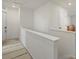Bright hallway with white walls, neutral carpet runner, and access to multiple rooms at 21901 E 42Nd Place, Aurora, CO 80019