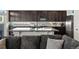 Modern kitchen with stainless steel appliances and a large island with bar seating at 21901 E 42Nd Place, Aurora, CO 80019
