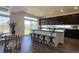 Open kitchen features a large island with bar seating, dark cabinets and stainless steel appliances at 21901 E 42Nd Place, Aurora, CO 80019