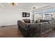 Cozy living room with hardwood floors, modern lighting, and a large sectional couch at 21901 E 42Nd Place, Aurora, CO 80019