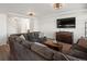 Inviting living room with a plush sectional sofa, wooden accents, and a mounted television at 21901 E 42Nd Place, Aurora, CO 80019