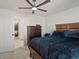 This main bedroom offers a walk-in closet, ceiling fan, and a warm and inviting atmosphere at 21901 E 42Nd Place, Aurora, CO 80019