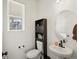 Elegant powder room features a pedestal sink and stylish fixtures for a modern touch at 21901 E 42Nd Place, Aurora, CO 80019