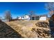 View of the expansive backyard featuring partial fencing and mature trees at 4752 E 108Th Pl, Thornton, CO 80233