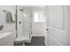 Modern bathroom featuring a glass-enclosed shower with white subway tile and sleek fixtures at 4752 E 108Th Pl, Thornton, CO 80233