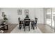 Well-lit dining area featuring modern artwork, a contemporary table set, and a seamless transition to the outdoors at 4752 E 108Th Pl, Thornton, CO 80233