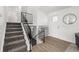 Inviting home entryway showcasing staircase with metal railings and wood-style flooring at 4752 E 108Th Pl, Thornton, CO 80233