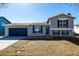 Charming gray two-story home with a blue garage door and shutters at 4752 E 108Th Pl, Thornton, CO 80233