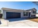 Charming gray two-story home with a blue garage door and shutters at 4752 E 108Th Pl, Thornton, CO 80233