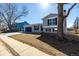 Charming gray two-story home with a blue garage door and shutters at 4752 E 108Th Pl, Thornton, CO 80233