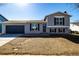 Charming gray two-story home with a blue garage door and shutters at 4752 E 108Th Pl, Thornton, CO 80233