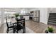 Modern kitchen and dining area featuring white cabinetry, stainless steel appliances, and plenty of natural light at 4752 E 108Th Pl, Thornton, CO 80233