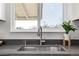 Modern kitchen with stainless steel sink, gray countertops, and a window providing natural light at 4752 E 108Th Pl, Thornton, CO 80233