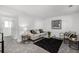 Stylish living room with modern decor, neutral walls, and a comfortable seating arrangement adjacent to a bright hallway at 4752 E 108Th Pl, Thornton, CO 80233