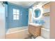 Modern bathroom featuring blue subway tile, stylish fixtures, and a sleek vanity at 1245 Leyden St, Denver, CO 80220