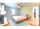 Bright bedroom featuring a ceiling fan, a comfortable bed, and a large window at 1245 Leyden St, Denver, CO 80220
