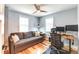 Versatile bedroom with a sofa, a desk, and natural light from two windows at 1245 Leyden St, Denver, CO 80220