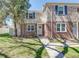 Charming brick home features blue shutters, a well-maintained lawn, and inviting walkway at 1245 Leyden St, Denver, CO 80220