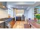 Bright kitchen with modern appliances, light wood cabinets, and a view to the rear yard at 1245 Leyden St, Denver, CO 80220