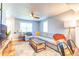 Bright living room with a large sofa, a modern ceiling fan, and stylish decor at 1245 Leyden St, Denver, CO 80220