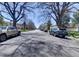 Tree-lined street view with well-maintained homes, showcasing neighborhood charm at 1245 Leyden St, Denver, CO 80220