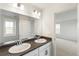 Bathroom with double vanity and view into bedroom at 20690 E 58Th Ave, Aurora, CO 80019