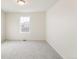 Well-lit bedroom featuring neutral walls and carpet at 20690 E 58Th Ave, Aurora, CO 80019