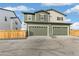 Two-car garage with driveway and wooden fence at 20690 E 58Th Ave, Aurora, CO 80019