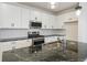 Modern kitchen with stainless steel appliances and granite countertops at 20690 E 58Th Ave, Aurora, CO 80019