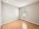 A minimalist bedroom with hardwood floors and a window for natural light at 10001 E Evans Ave # 81C, Aurora, CO 80247