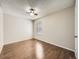 A bright, minimalist bedroom with hardwood floors, a ceiling fan, and a window at 10001 E Evans Ave # 81C, Aurora, CO 80247