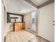 A dining area featuring tile floors, a modern mirror accent, and a large window for natural light at 10001 E Evans Ave # 81C, Aurora, CO 80247