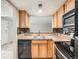 Galley kitchen featuring stainless steel appliances, tile backsplash, and light wood cabinetry at 10001 E Evans Ave # 81C, Aurora, CO 80247