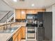 A kitchen featuring stainless steel appliances, tile backsplash, and light wood cabinetry at 10001 E Evans Ave # 81C, Aurora, CO 80247