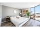 Cozy bedroom featuring a comfortable bed, stylish decor, and large window with cityscape views for a tranquil retreat at 1625 Larimer St # 2501, Denver, CO 80202