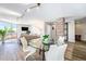 Bright dining area with a glass table and modern white chairs, adjacent to the living room and offering city views at 1625 Larimer St # 2501, Denver, CO 80202