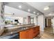 Open concept kitchen area features wooden cabinets, tile backsplash, and breakfast bar overlooking the inviting living space at 1625 Larimer St # 2501, Denver, CO 80202