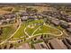 Aerial view of a green space and playground area nestled among houses, offering a Gathering-friendly community atmosphere at 11828 Churchfield St, Parker, CO 80134