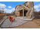 Outdoor patio area with red Adirondack chairs and access to upper deck with stairs at 11828 Churchfield St, Parker, CO 80134