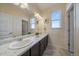 Bathroom featuring double sinks, a large vanity, and tile flooring offering a clean and functional space at 11828 Churchfield St, Parker, CO 80134