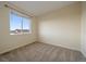 Bright bedroom with large window offering ample natural light and neutral carpeting for a cozy feel at 11828 Churchfield St, Parker, CO 80134