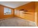 An empty bedroom with carpet, neutral walls, and three floating shelves at 11828 Churchfield St, Parker, CO 80134