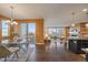 Open concept dining room with a glass table, hardwood floors, and access to an outdoor deck at 11828 Churchfield St, Parker, CO 80134