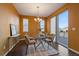 Dining room with modern table and chairs next to a sliding door leading to a deck at 11828 Churchfield St, Parker, CO 80134