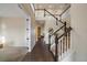 Grand foyer with hardwood floors, staircase with white railings, and plenty of natural light at 11828 Churchfield St, Parker, CO 80134