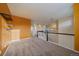 Open hallway with carpeting, yellow walls, and white banister offers a spacious, bright transition between rooms at 11828 Churchfield St, Parker, CO 80134