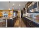 Kitchen featuring stainless steel appliances, granite countertops, and dark wood cabinetry at 11828 Churchfield St, Parker, CO 80134