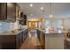 Kitchen island with seating overlooks a dining area and living room at 11828 Churchfield St, Parker, CO 80134